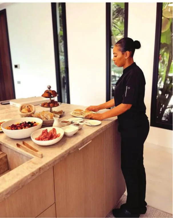 Jen the Chef setting the breakfast table in a St Barts villa kitchen